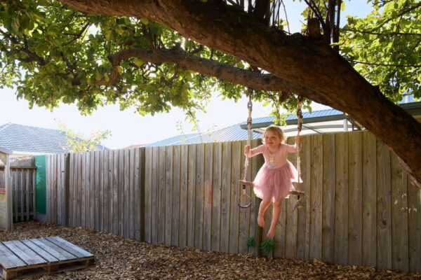 girl on swing at portobelo avonhead
